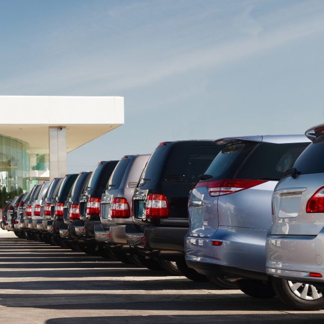 auto dealerships lot with new SUVs