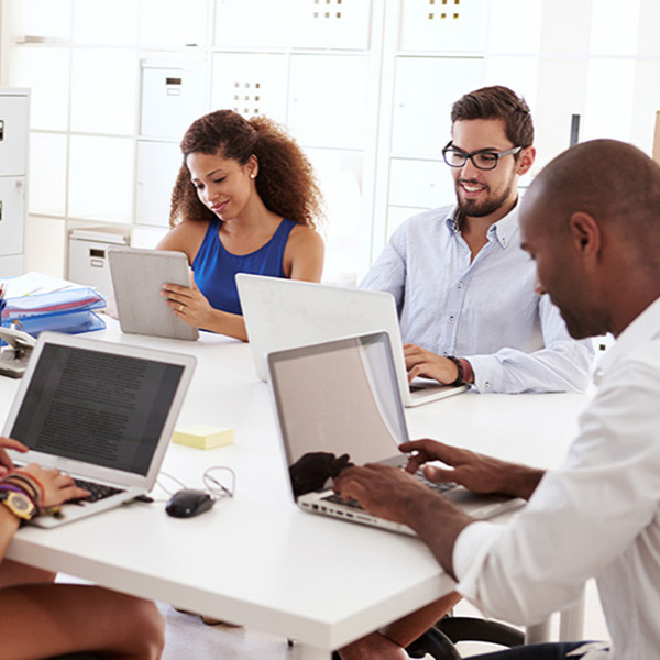 workers on their laptops and tablets
